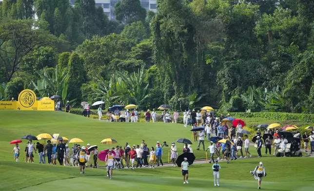 Yuka Saso of Japan, second right in front, walks on the 2nd fairway during the first round of Maybank LPGA Championship golf tournament at Kuala Lumpur Golf and Country club in Kuala Lumpur, Thursday, Oct. 24, 2024. (AP Photo/Vincent Thian)