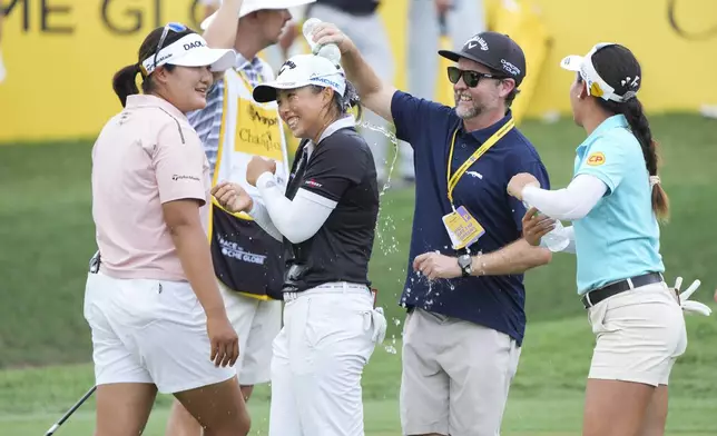 Yin Ruoning of China, centre, celebrates on the 18th hole after winning the LPGA Tour's Maybank Championship at Kuala Lumpur Golf and Country club in Kuala Lumpur, Sunday, Oct. 27, 2024. (AP Photo/Vincent Thian)