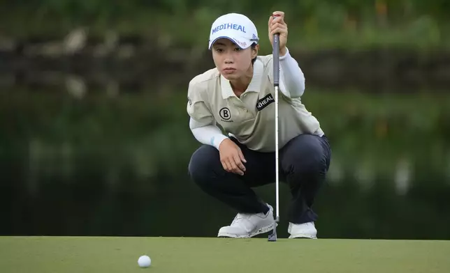 Narin An of South Korea lines up a putt on the 2nd green during the first round of Maybank LPGA Championship golf tournament at Kuala Lumpur Golf and Country club in Kuala Lumpur, Thursday, Oct. 24, 2024. (AP Photo/Vincent Thian)