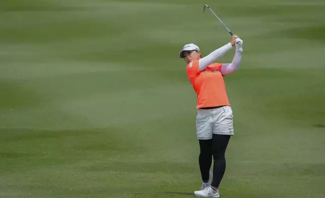 Mao Saigo of Japan watches her shot on the 9th fairway at the 9th green during the first round of Maybank LPGA Championship golf tournament at Kuala Lumpur Golf and Country club in Kuala Lumpur, Thursday, Oct. 24, 2024. (AP Photo/Vincent Thian)