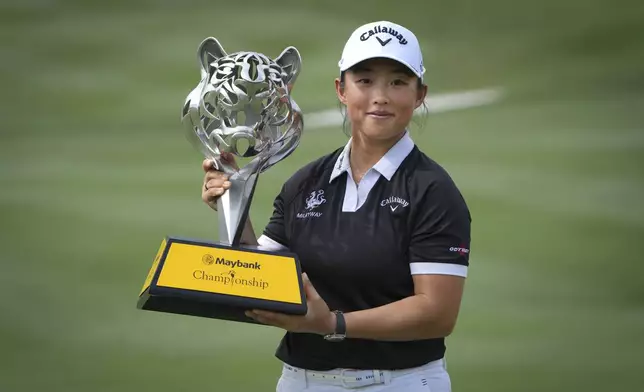 Yin Ruoning of China holds the winning trophy during the awards ceremony after winning the LPGA Tour's Maybank Championship at Kuala Lumpur Golf and Country club in Kuala Lumpur, Sunday, Oct. 27, 2024. (AP Photo/Vincent Thian)