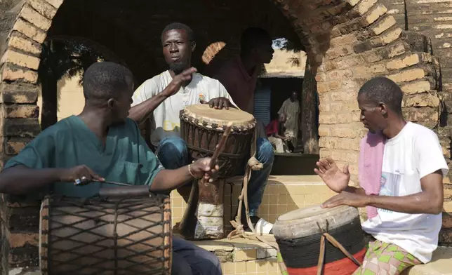 Patients at Bamako's Point G psychiatric ward play instruments in the hospital's courtyard in Bamako, Mali, Friday, Sept. 20, 2024. (AP Photo/Moustapha Diallo)