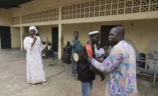 Patients at Bamako's Point G psychiatric ward act out scenes at the psychiatric ward of the Point G hospital in Bamako, Mali, Friday, Sept. 20, 2024. (AP Photo/Moustapha Diallo)