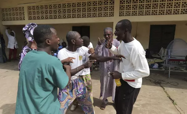 Patients at Bamako's Point G psychiatric ward act out scenes at the psychiatric ward of the Point G hospital in Bamako, Mali, Friday, Sept. 20, 2024. (AP Photo/Moustapha Diallo)