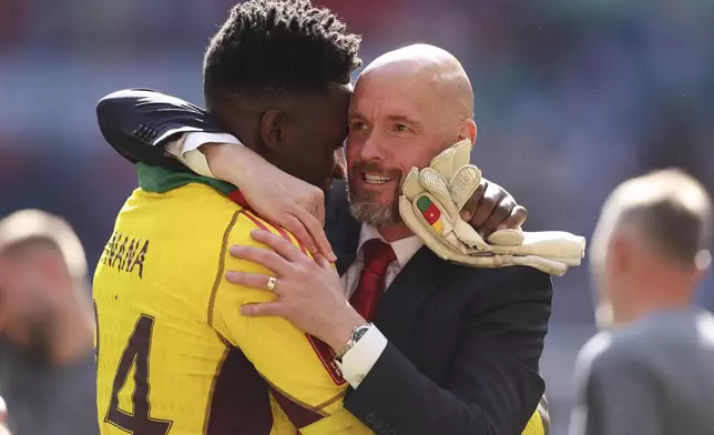 FILE - Manchester United's head coach Erik ten Hag celebrates with Manchester United's goalkeeper Andre Onana after winning the English FA Cup final soccer match between Manchester City and Manchester United at Wembley Stadium in London, Saturday, May 25, 2024. (AP Photo/Ian Walton, File)