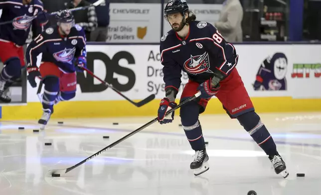 Columbus Blue Jackets forward Kirill Marchenko warms up before an NHL hockey game against the Toronto Maple Leafs in Columbus, Ohio, Tuesday, Oct. 22, 2024. (AP Photo/Paul Vernon)