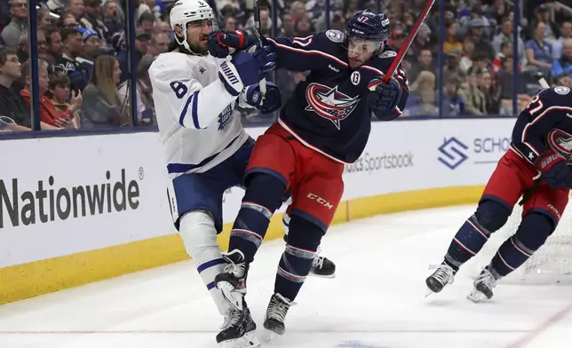 Columbus Blue Jackets forward Justin Danforth, right, checks Toronto Maple Leafs defenseman Christopher Tanev during the second period of an NHL hockey game in Columbus, Ohio, Tuesday, Oct. 22, 2024. (AP Photo/Paul Vernon)