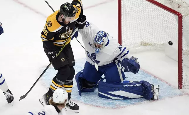 Boston Bruins' Justin Brazeau (55) screens Toronto Maple Leafs' Anthony Stolarz (41) as a shot goes wide during the first period of an NHL hockey game, Saturday, Oct. 26, 2024, in Boston. (AP Photo/Michael Dwyer)