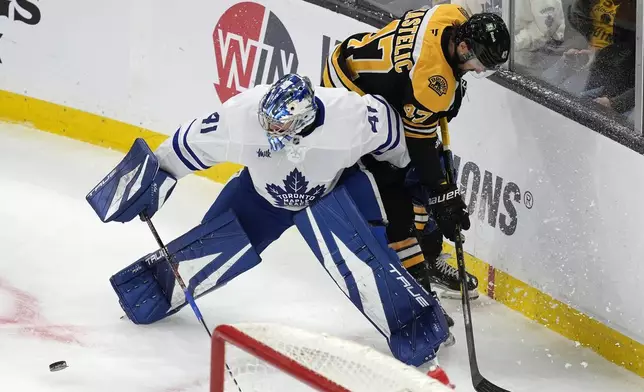 Boston Bruins' Mark Kastelic (47) battles Toronto Maple Leafs' Anthony Stolarz (41) during the first period of an NHL hockey game, Saturday, Oct. 26, 2024, in Boston. (AP Photo/Michael Dwyer)