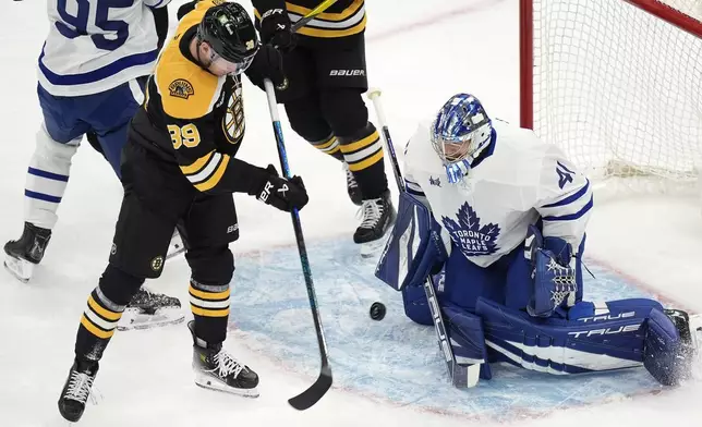 Boston Bruins' Morgan Geekie (39) shoots on Toronto Maple Leafs' Anthony Stolarz (41) during the first period of an NHL hockey game, Saturday, Oct. 26, 2024, in Boston. (AP Photo/Michael Dwyer)