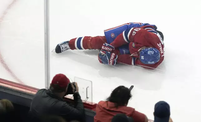 Montreal Canadiens' Patrik Laine (92) lies on the ice after a collision with a Toronto Maple Leafs player during the first of an NHL preseason hockey game in Montreal, Saturday, Sept. 28, 2024. (Evan Buhler/The Canadian Press via AP)