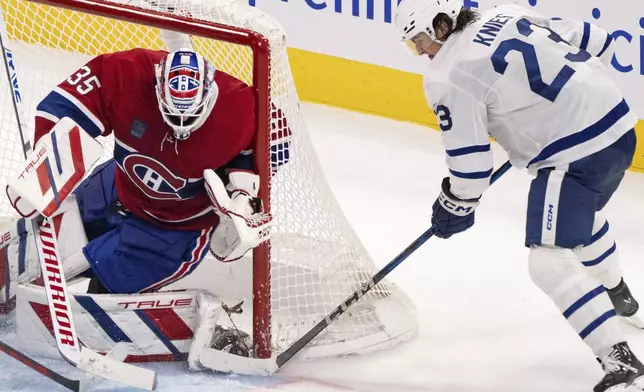 Montreal Canadiens goaltender Sam Montembeault (35) stops a shot by Toronto Maple Leafs' Matthew Knies (23) during the third period of an NHL hockey game, Wednesday, Oct. 9, 2024 in Montreal. (Christinne Muschi/Canadian Press via AP)