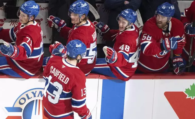 Montreal Canadiens' Cole Caufield (13) celebrates his goal against the Toronto Maple Leafs during the first period of an NHL hockey game, Wednesday, Oct. 9, 2024 in Montreal. (Christinne Muschi/Canadian Press via AP)