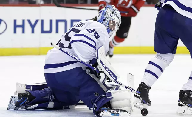 Toronto Maple Leafs goaltender Dennis Hildeby (35) makes a save during the second period of an NHL hockey game against the New Jersey Devils Thursday, Oct. 10, 2024, in Newark, N.J. (AP Photo/Adam Hunger)