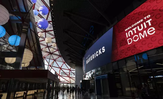 Fans enter the Intuit Dome, the new home of the Los Angeles Clippers, before the team's NBA preseason basketball game against the Dallas Mavericks Monday, Oct. 14, 2024, in Inglewood, Calif. (AP Photo/Jae C. Hong)