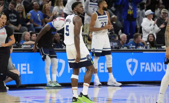 Minnesota Timberwolves guard Anthony Edwards (5) celebrates after making a 3-point shot during the first half of an NBA basketball game against the Dallas Mavericks, Tuesday, Oct. 29, 2024, in Minneapolis. (AP Photo/Abbie Parr)