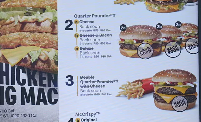 The electronic menu order board still displays Quarter Pounder hamburgers but with a prompt to tell consumers they will be available soon at a McDonald's drive-thru Wednesday, Oct. 23, 2024, in Littleton, Colo. (AP Photo/David Zalubowski)