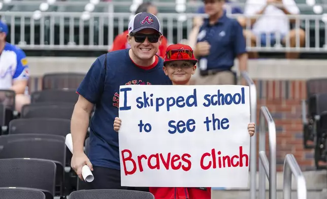 Atlanta Braves fans await for the start of a baseball game against the New York Mets, Monday, Sept. 30, 2024, in Atlanta. (AP Photo/Jason Allen)