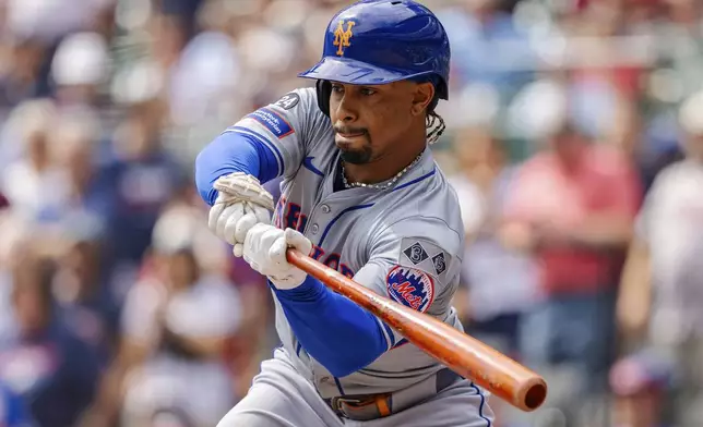 New York Mets' Francisco Lindor checks his swing in the third inning of a baseball game against the Atlanta Braves, Monday, Sept. 30, 2024, in Atlanta. (AP Photo/Jason Allen)