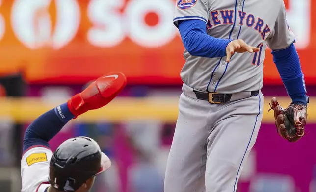 New York Mets second baseman Jose Iglesias, right, tags second base and throws to first before Atlanta Braves' Ozzie Albies, left, can slide into the bag in the fifth inning of a baseball game, Monday, Sept. 30, 2024, in Atlanta. (AP Photo/Jason Allen)