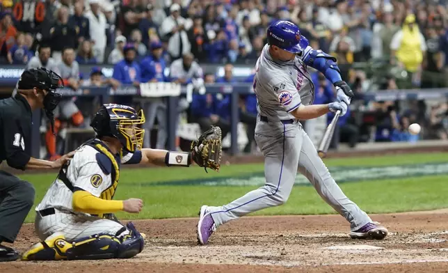 New York Mets' Pete Alonso hits a three-run home run during the ninth inning of Game 3 of a National League wild card baseball game against the Milwaukee Brewers Thursday, Oct. 3, 2024, in Milwaukee. (AP Photo/Morry Gash)