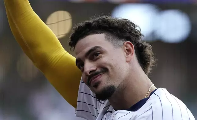 Milwaukee Brewers' Willy Adames gestures as he jogs to the dugout after being taken out of the game during the seventh inning of a baseball game against the New York Mets, Sunday, Sept. 29, 2024, in Milwaukee. (AP Photo/Aaron Gash)