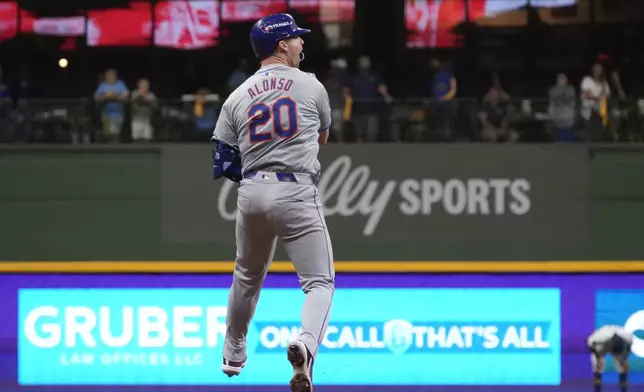 New York Mets' Pete Alonso reacts after hitting a three-run home run during the ninth inning of Game 3 of a National League wild card baseball game against the Milwaukee Brewers Thursday, Oct. 3, 2024, in Milwaukee. (AP Photo/Morry Gash)