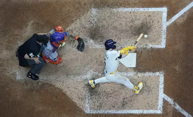 Milwaukee Brewers' Garrett Mitchell hits a two-run home run during the eighth inning of Game 2 of a National League wild card baseball game against the New York Mets Wednesday, Oct. 2, 2024, in Milwaukee. (AP Photo/Morry Gash)