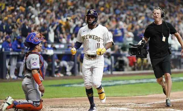 Milwaukee Brewers' Jackson Chourio hits a home run during the eighth inning of Game 2 of a National League wild card baseball game against the New York Mets Wednesday, Oct. 2, 2024, in Milwaukee. (AP Photo/Morry Gash)