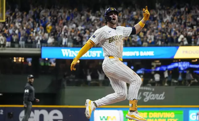 Milwaukee Brewers' Garrett Mitchell celebrates afrer hitting a two-run home run during the eighth inning of Game 2 of a National League wild card baseball game against the New York Mets Wednesday, Oct. 2, 2024, in Milwaukee. (AP Photo/Morry Gash)