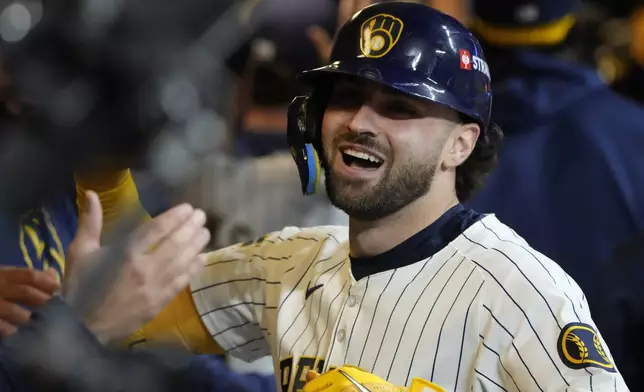 Milwaukee Brewers' Garrett Mitchell celebrates afrer hitting a two-run home run during the eighth inning of Game 2 of a National League wild card baseball game against the New York Mets Wednesday, Oct. 2, 2024, in Milwaukee. (AP Photo/Morry Gash)