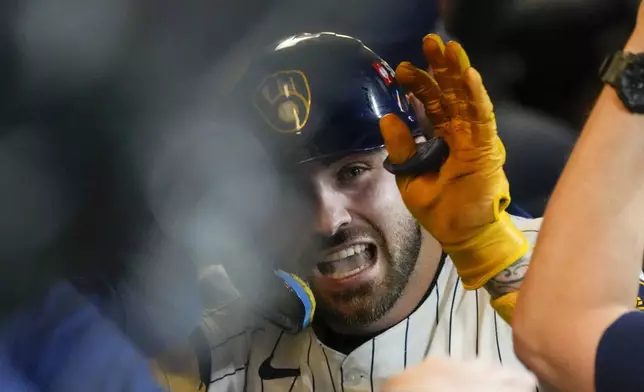 Milwaukee Brewers' Garrett Mitchell celebrates afrer hitting a two-run home run during the eighth inning of Game 2 of a National League wild card baseball game against the New York Mets Wednesday, Oct. 2, 2024, in Milwaukee. (AP Photo/Morry Gash)