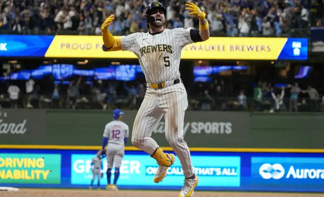 Milwaukee Brewers' Garrett Mitchell celebrates afrer hitting a two-run home run during the eighth inning of Game 2 of a National League wild card baseball game against the New York Mets Wednesday, Oct. 2, 2024, in Milwaukee. (AP Photo/Morry Gash)