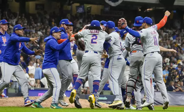 The New York Mets celebrate after winning Game 3 of a National League wild card baseball game against the Milwaukee Brewers Thursday, Oct. 3, 2024, in Milwaukee. The Mets won 4-2. (AP Photo/Morry Gash)