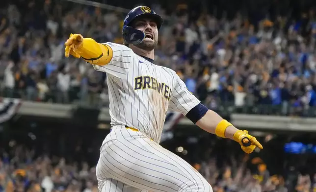 Milwaukee Brewers' Garrett Mitchell celebrates afrer hitting a two-run home run during the eighth inning of Game 2 of a National League wild card baseball game against the New York Mets Wednesday, Oct. 2, 2024, in Milwaukee. (AP Photo/Morry Gash)