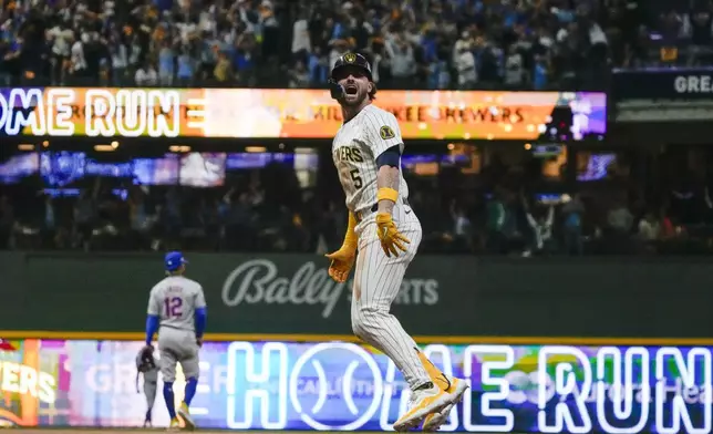 Milwaukee Brewers' Garrett Mitchell celebrates afrer hitting a two-run home run during the eighth inning of Game 2 of a National League wild card baseball game against the New York Mets Wednesday, Oct. 2, 2024, in Milwaukee. (AP Photo/Morry Gash)