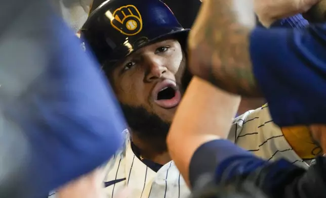 Milwaukee Brewers' Jackson Chourio is congratulated after hitting a home run during the eighth inning of Game 2 of a National League wild card baseball game against the New York Mets Wednesday, Oct. 2, 2024, in Milwaukee. (AP Photo/Morry Gash)