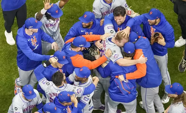 The New York Mets celebrate after winning Game 3 of a National League wild card baseball game against the Milwaukee Brewers Thursday, Oct. 3, 2024, in Milwaukee. The Mets won 4-2. (AP Photo/Morry Gash)