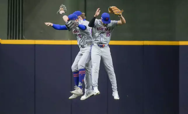 New York Mets' Brandon Nimmo, Harrison Bader, and Tyrone Taylor celebrate after Game 2 of a National League wild card baseball game against the Milwaukee Brewers Tuesday, Oct. 1, 2024, in Milwaukee. The Mets won 8-4. (AP Photo/Morry Gash)