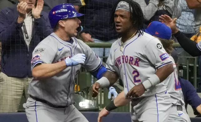 New York Mets' Pete Alonso celebrates his three-run home run with Luisangel Acuña during the ninth inning of Game 3 of a National League wild card baseball game against the Milwaukee Brewers Thursday, Oct. 3, 2024, in Milwaukee. (AP Photo/Morry Gash)