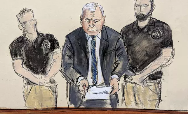 Genaro Garcia Luna stands flanked by U.S. Marshals as he reads his sentencing statement during his sentencing hearing, Wednesday, Oct. 16, 2024, at Brooklyn federal court in New York. (Elizabeth Williams via AP)