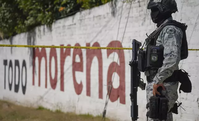 A National Guardsman stand guard over a scene where a car bomb exploded near a police station in Acambaro, Guanajuato state, Mexico, Thursday, Oct. 24, 2024. (AP Photo/Armando Solis)