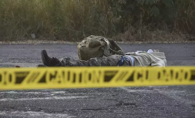 Caution tape surrounds a body lying on the street Culiacan, Sinaloa state, Mexico, Monday, Oct. 14, 2024. (AP Photo)