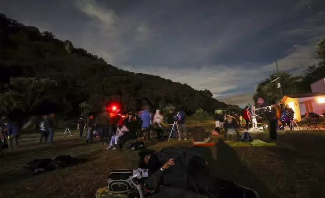 People attend a stargazing and comet-watching gathering at Joya-La Barreta ecological park in Queretaro, Mexico, Saturday, Oct. 19, 2024. (AP Photo/Ginnette Riquelme)