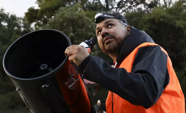 Juan Carlos Hernandez, the president of Queretaro’s Astronomical Society, sets up a telescope before a stargazing and comet-watching gathering at Joya-La Barreta Ecological Park in Queretaro, Mexico, Saturday, Oct. 19, 2024. (AP Photo/Ginnette Riquelme)