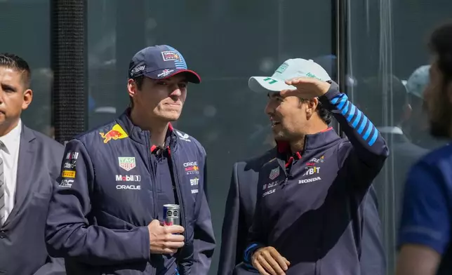 Red Bull drivers Max Verstappen, from the Netherlands, left, and Sergio Perez, from Mexico, attend a promotional event in Mexico City, Wednesday, Oct. 23, 2024, ahead of the weekend Formula One Mexico Grand Prix auto race. (AP Photo/Moises Castillo)