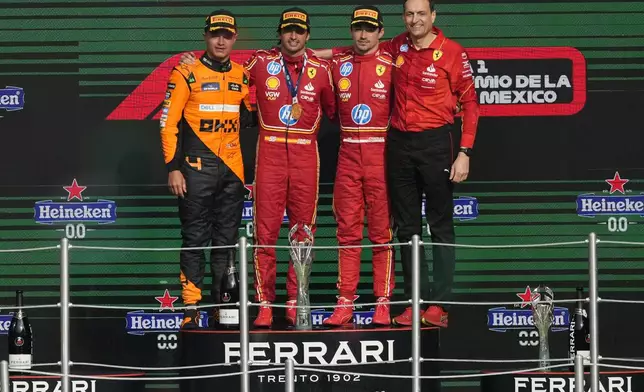 From left, McLaren driver Lando Norris of Britain, second place, Ferrari driver Carlos Sainz of Spain, first place, Ferrari driver Charles Leclerc of Monaco, third place, and Riccardo Adami of Ferrari pose on the podium for the Formula One Mexico Grand Prix auto race at the Hermanos Rodriguez racetrack in Mexico City, Sunday, Oct. 27, 2024. (AP Photo/Eduardo Verdugo)