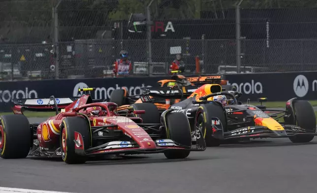 Carlos Sainz, of Spain, steers his Ferrari followed by Red Bull driver Max Verstappen of the Netherlands during the Formula One Mexico Grand Prix auto race at the Hermanos Rodriguez racetrack in Mexico City, Sunday, Oct. 27, 2024. (AP Photo/Moises Castillo)