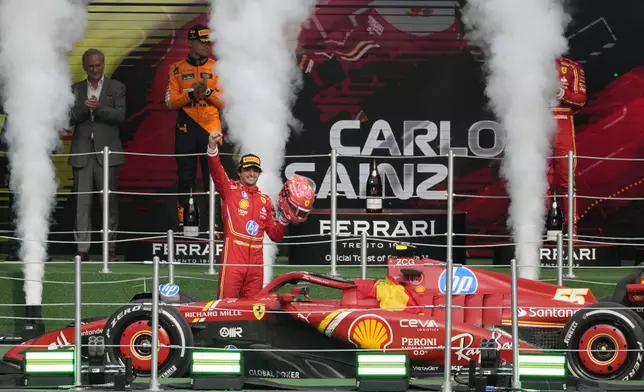 Ferrari driver Carlos Sainz of Spain celebrates after winning the Formula One Mexico Grand Prix auto race at the Hermanos Rodriguez racetrack in Mexico City, Sunday, Oct. 27, 2024. (AP Photo/Eduardo Verdugo)