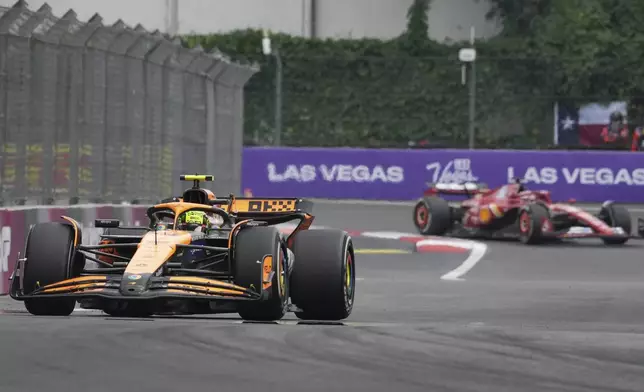 Lando Norris, of Britain, steers his McLaren followed by Ferrari driver Charles Leclerc of Monaco during the Formula One Mexico Grand Prix auto race at the Hermanos Rodriguez racetrack in Mexico City, Sunday, Oct. 27, 2024. (AP Photo/Fernando Llano)